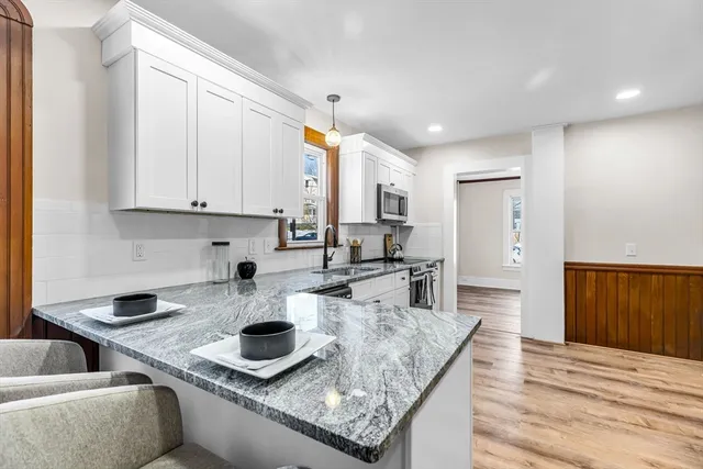 a kitchen with stainless steel appliances granite countertop a granite counter tops and a stove