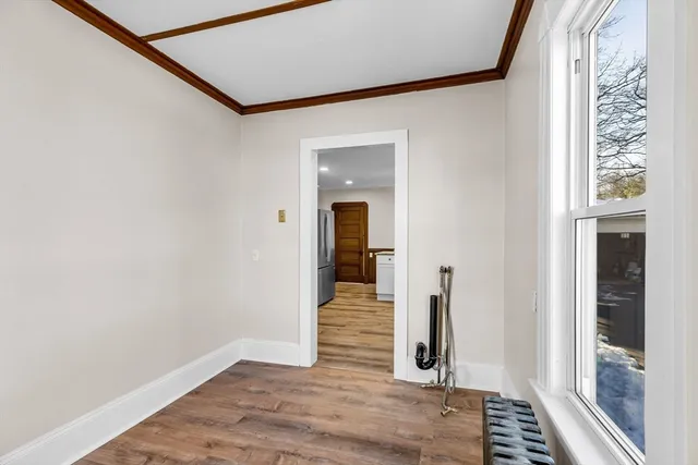 a view of a hallway with wooden floor and staircase