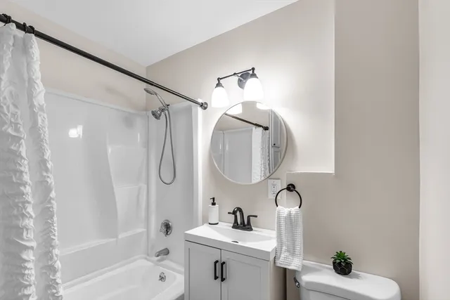 a bathroom with a sink a toilet and a mirror