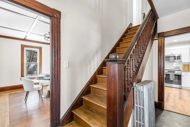 a view of entryway and hall with wooden floor