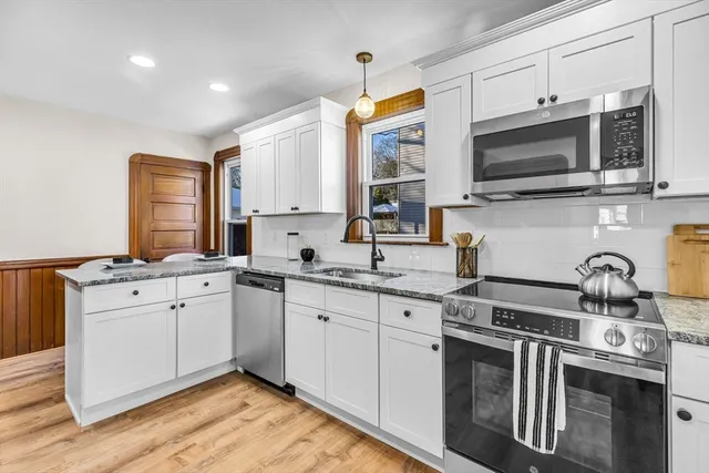 a kitchen with stainless steel appliances a sink stove and microwave