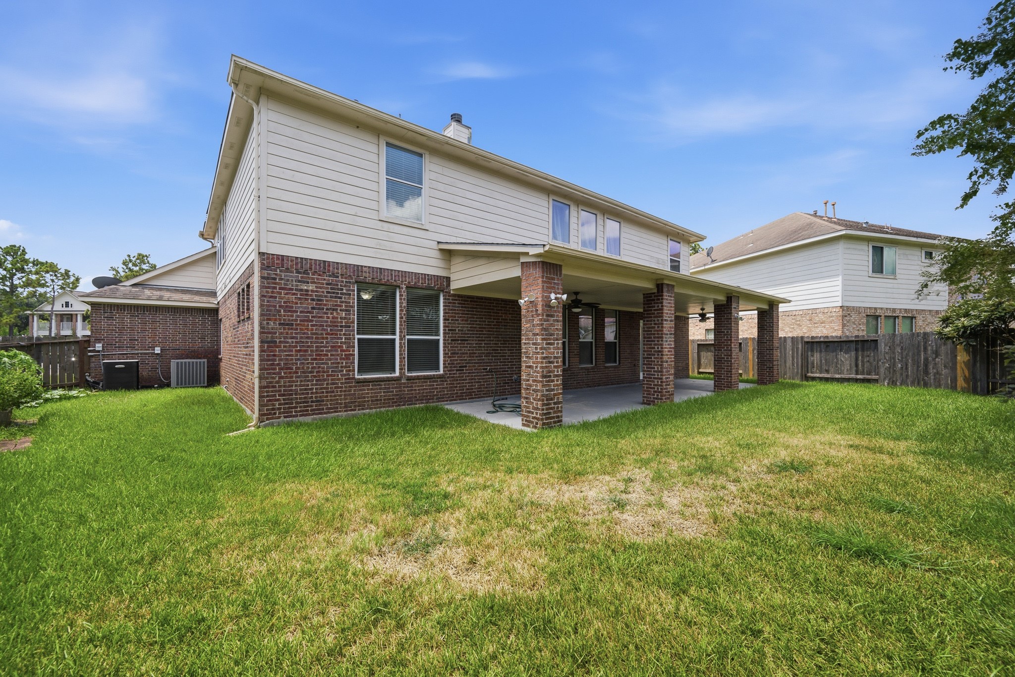 2117 Rushing Spring Drive Pearland, TX 77584 - Photo 42 of 42 Discover the charm of this home's inviting back area, featuring a spacious covered patio perfect for outdoor gatherings and a lush green lawn ideal for relaxation and play.