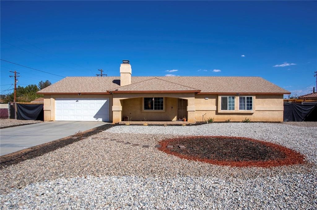 15591 Rancherias Road Apple Valley, CA 92307 - Photo 1 of 1 a front view of a house with a yard