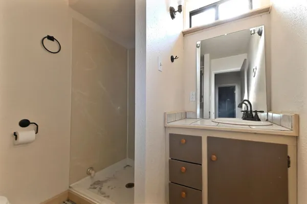 an empty room with a empty shelves and natural light