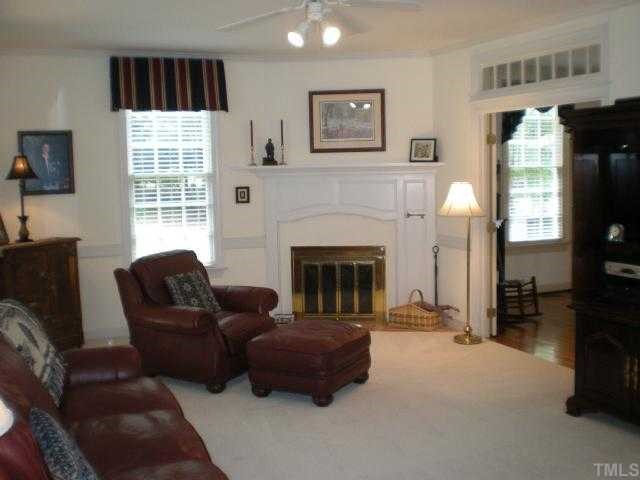 2300 Countrywood Road North Raleigh, NC 27615 - Photo 3 of 12 a living room with furniture and a fireplace