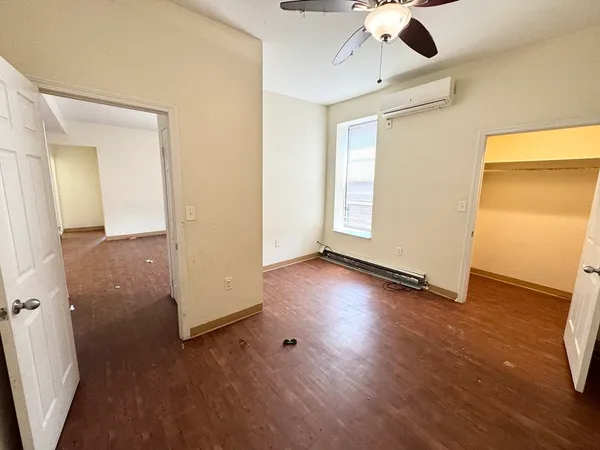 wooden floor in an empty room with a window