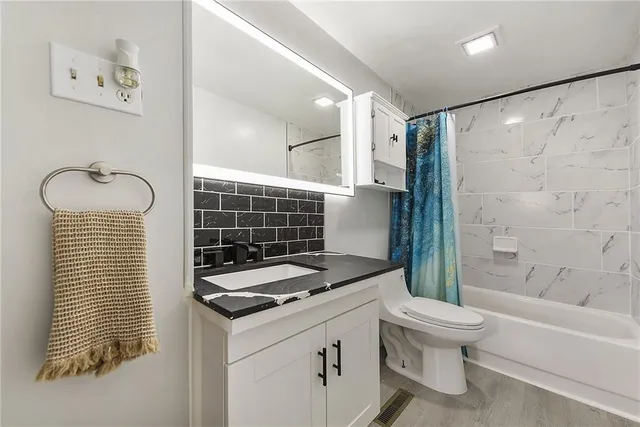 a bathroom with a sink toilet and shower