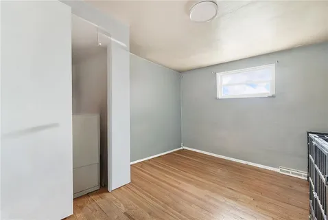 a view of a room with wooden floor and fan