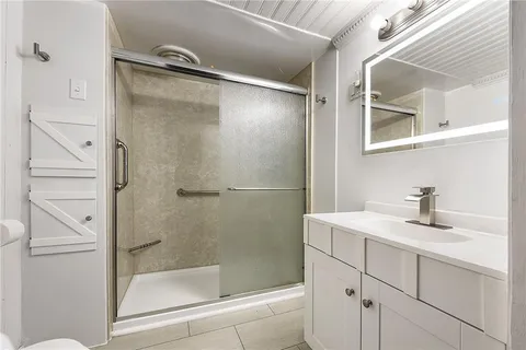 a bathroom with a shower and a sink