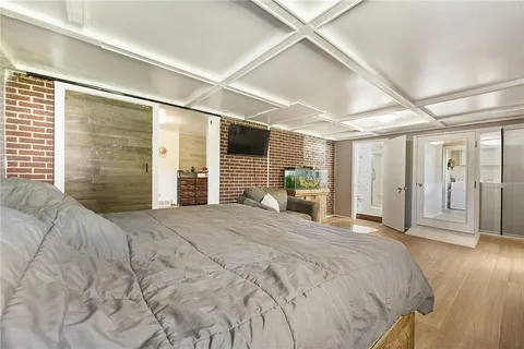 a bedroom with a large bed and a window