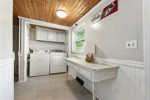 a kitchen with a stove sink and cabinets
