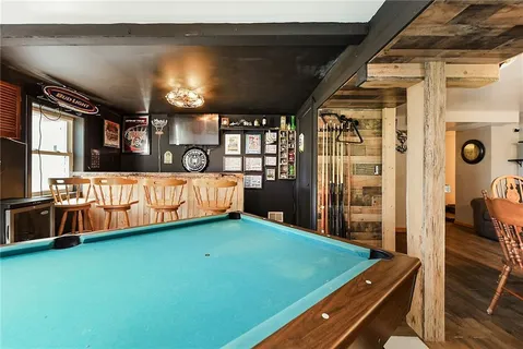 a room with pool table and windows