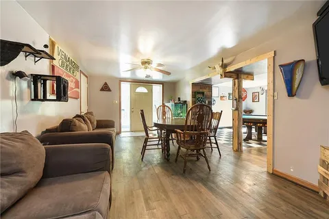 a living room with furniture wooden floor and a flat screen tv