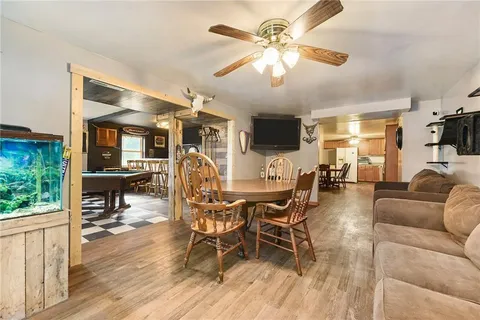 a living room with furniture a flat screen tv and a large window
