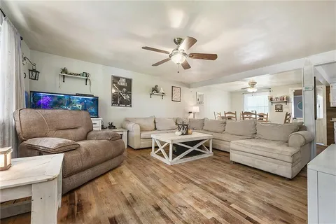 a living room with furniture and a ceiling fan