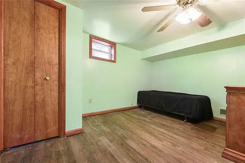 a bedroom with a bed and a ceiling fan
