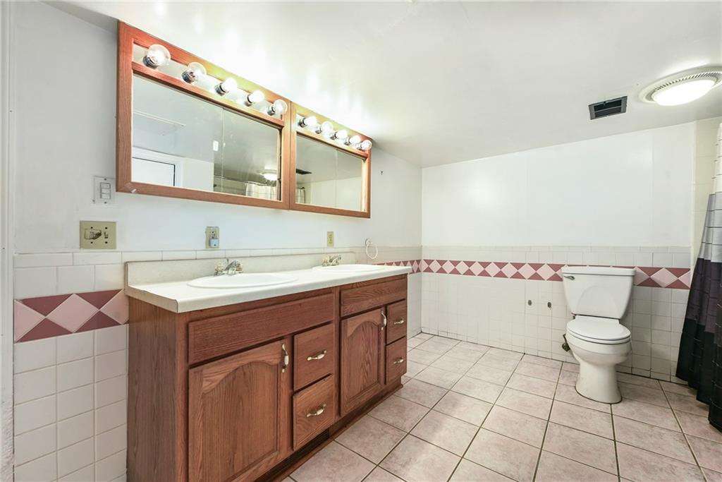 3330 Overland Drive Irwin, PA 15642 - Photo 35 of 44 a spacious bathroom with a toilet sink and mirror