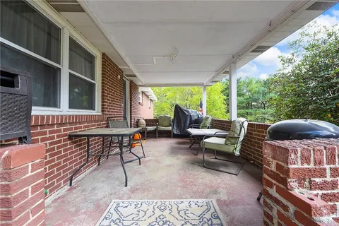 a patio with patio couch and chairs