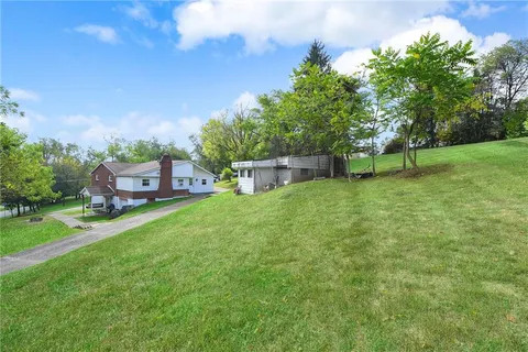a view of a garden with a bench in the garden
