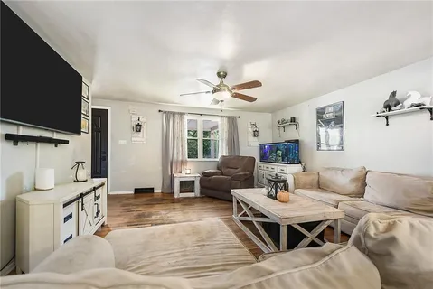 a living room with furniture and a flat screen tv