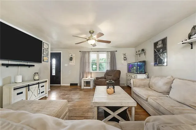 a living room with furniture and a flat screen tv