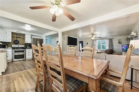 a view of a dining room with furniture and a kitchen
