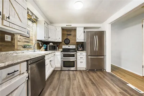 a kitchen with a refrigerator stove and sink
