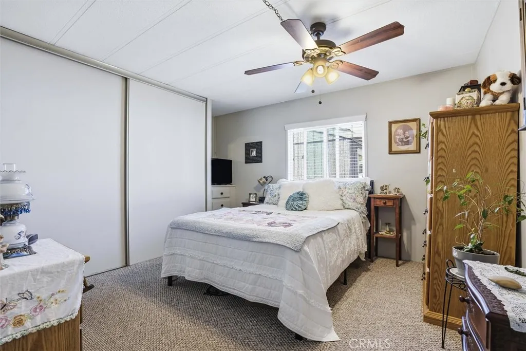 500 Atascadero, Unit D8 Morro Bay, CA 93442 - Photo 13 of 26 a spacious bedroom with a bed and a chandelier