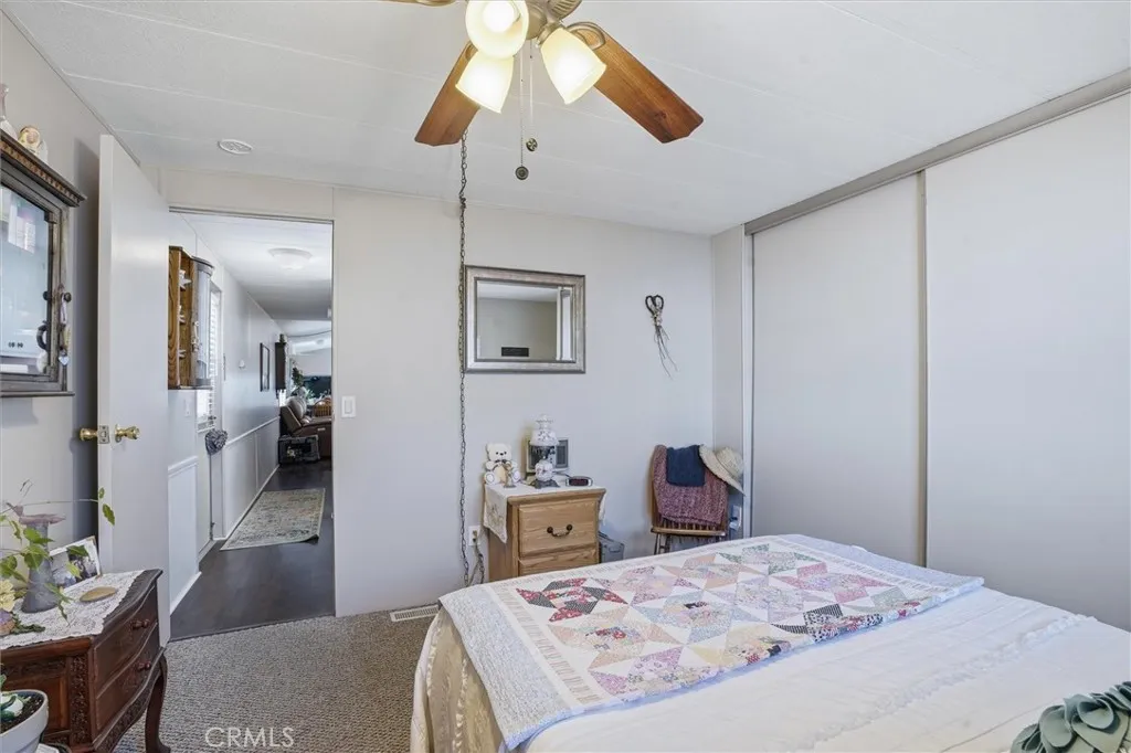 500 Atascadero, Unit D8 Morro Bay, CA 93442 - Photo 14 of 26 a bedroom with a bed and a chandelier