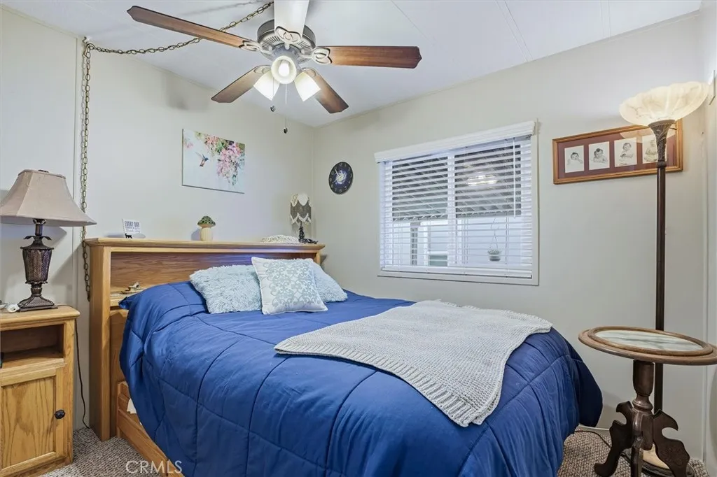 500 Atascadero, Unit D8 Morro Bay, CA 93442 - Photo 17 of 26 a bedroom with a bed and a chandelier