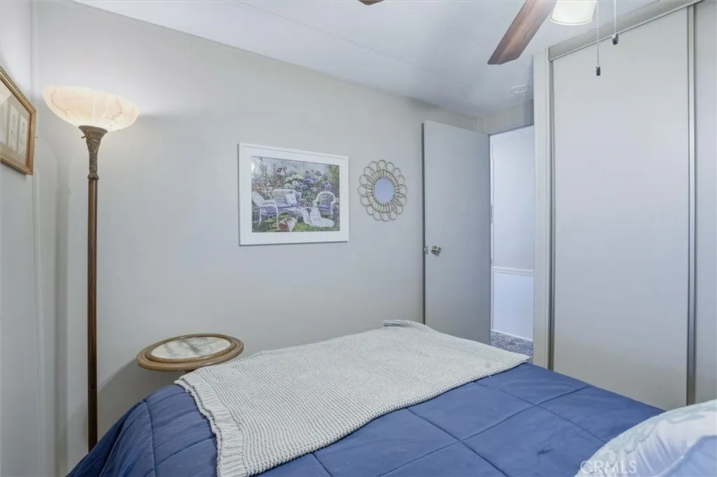 500 Atascadero, Unit D8 Morro Bay, CA 93442 - Photo 18 of 26 a bedroom with a bed and a painting on the wall