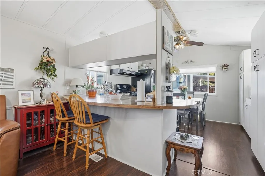 500 Atascadero, Unit D8 Morro Bay, CA 93442 - Photo 9 of 26 a view of dining room and kitchen with furniture wooden floor and a chandelier