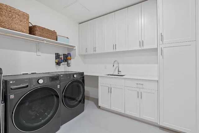 a utility room with sink dryer and washer