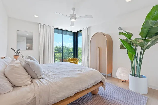a bedroom with a bed and a potted plant