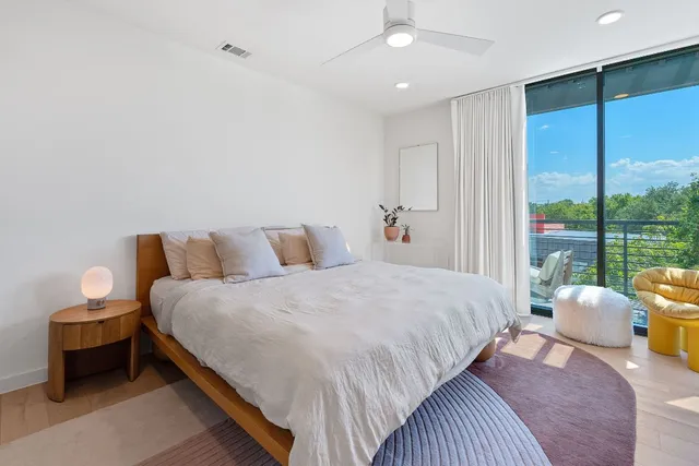 a bedroom with a bed and large window