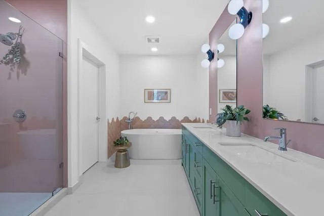 a bathroom with a granite countertop sink a large mirror and shower