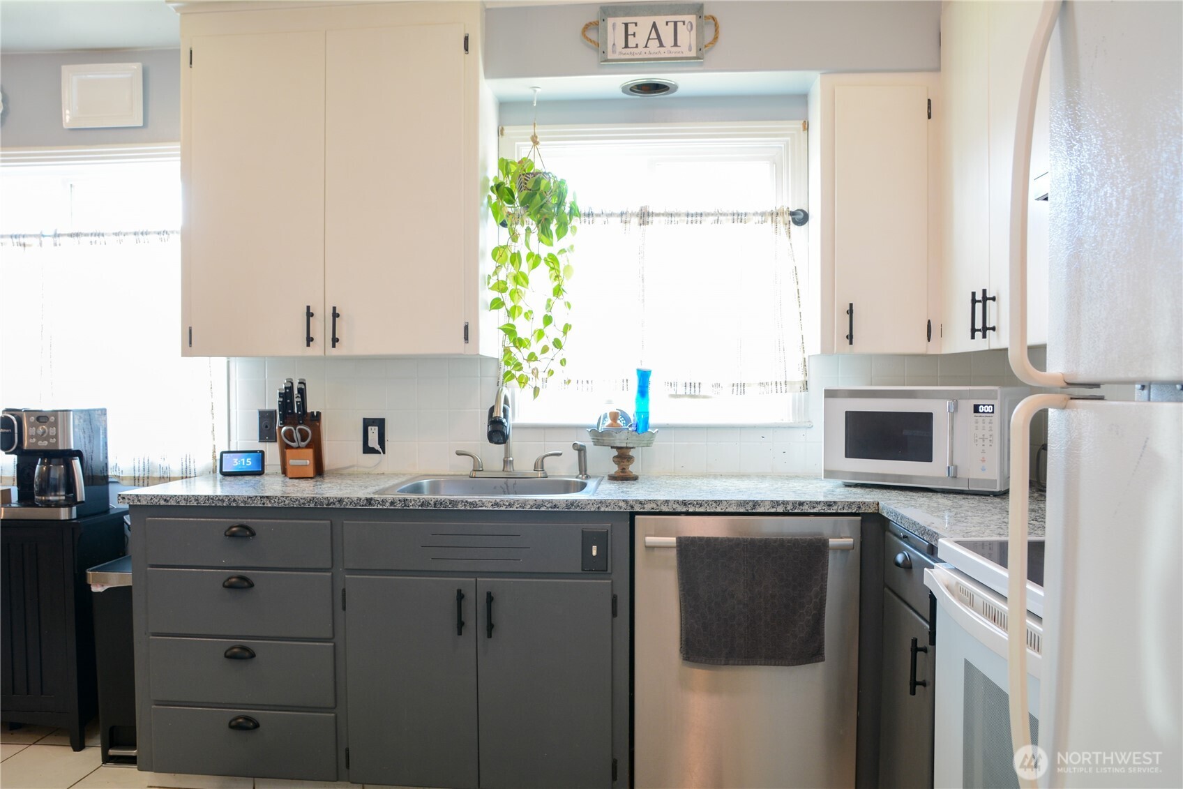 207 West 10th Avenue Ritzville, WA 99169 - Photo 11 of 36 a kitchen with granite countertop a sink stainless steel appliances and cabinets