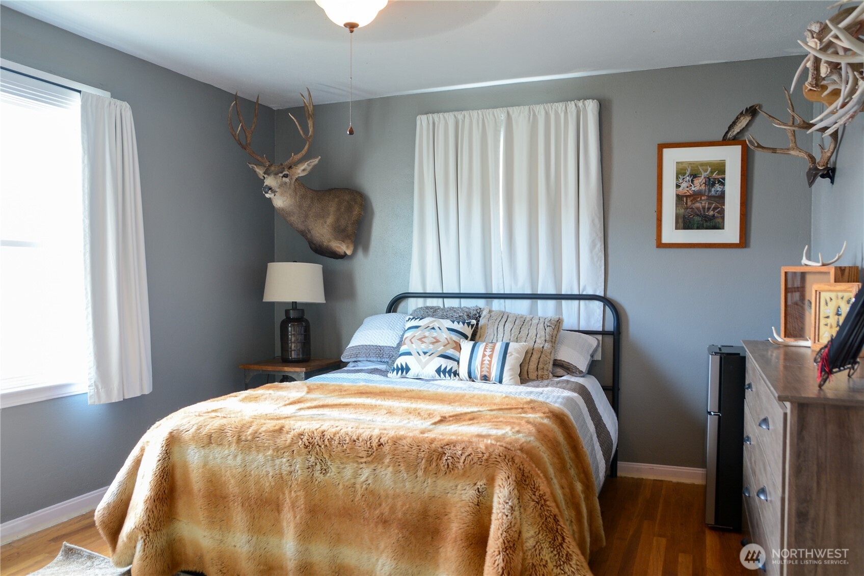 207 West 10th Avenue Ritzville, WA 99169 - Photo 21 of 36 a bedroom with a bed and painting on the wall
