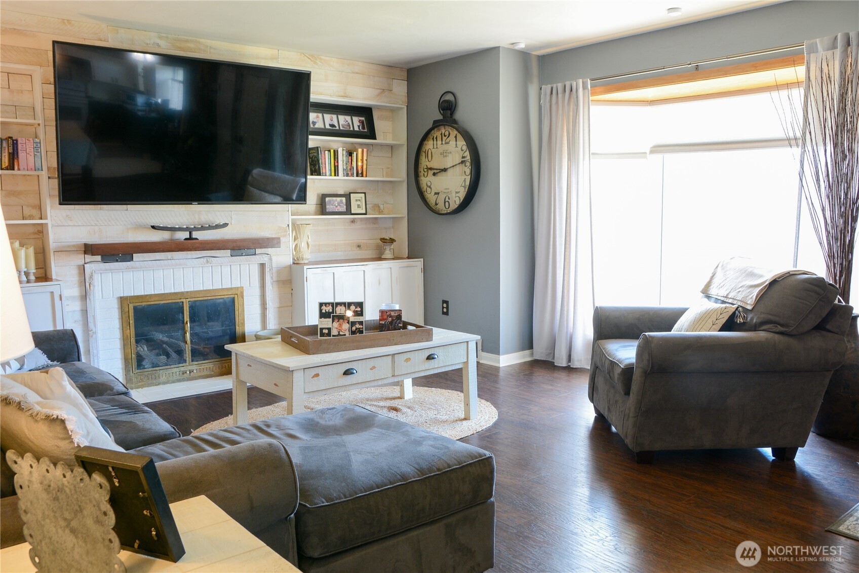 207 West 10th Avenue Ritzville, WA 99169 - Photo 4 of 36 a living room with furniture a flat screen tv and a fireplace