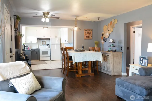 a living room with furniture and a dining table