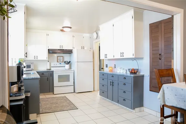 a kitchen with cabinets appliances and furniture