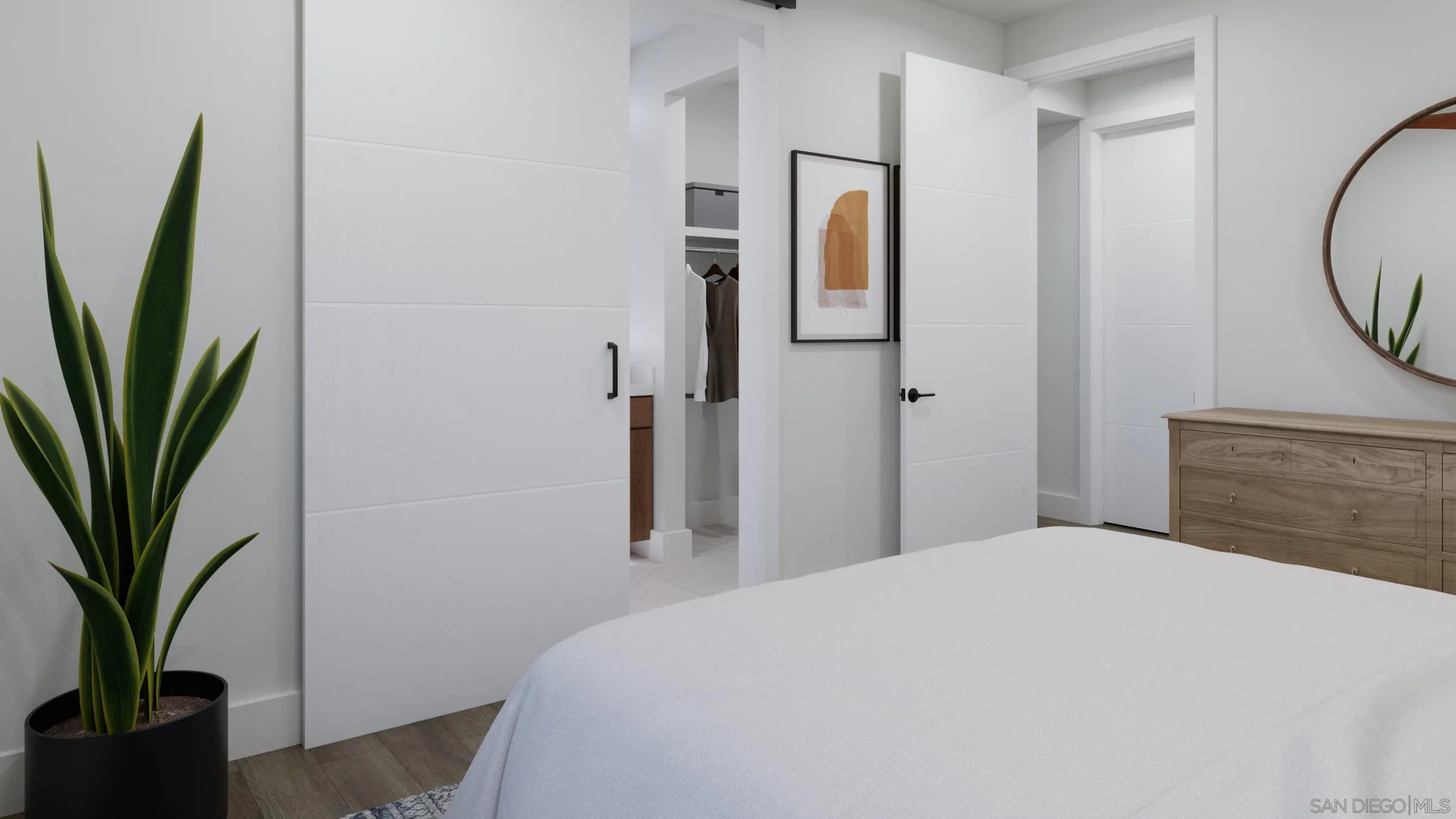 2501 State Street, Unit 202 Carlsbad, CA 92008 - Photo 9 of 15 a bedroom with a large bed and a potted plant