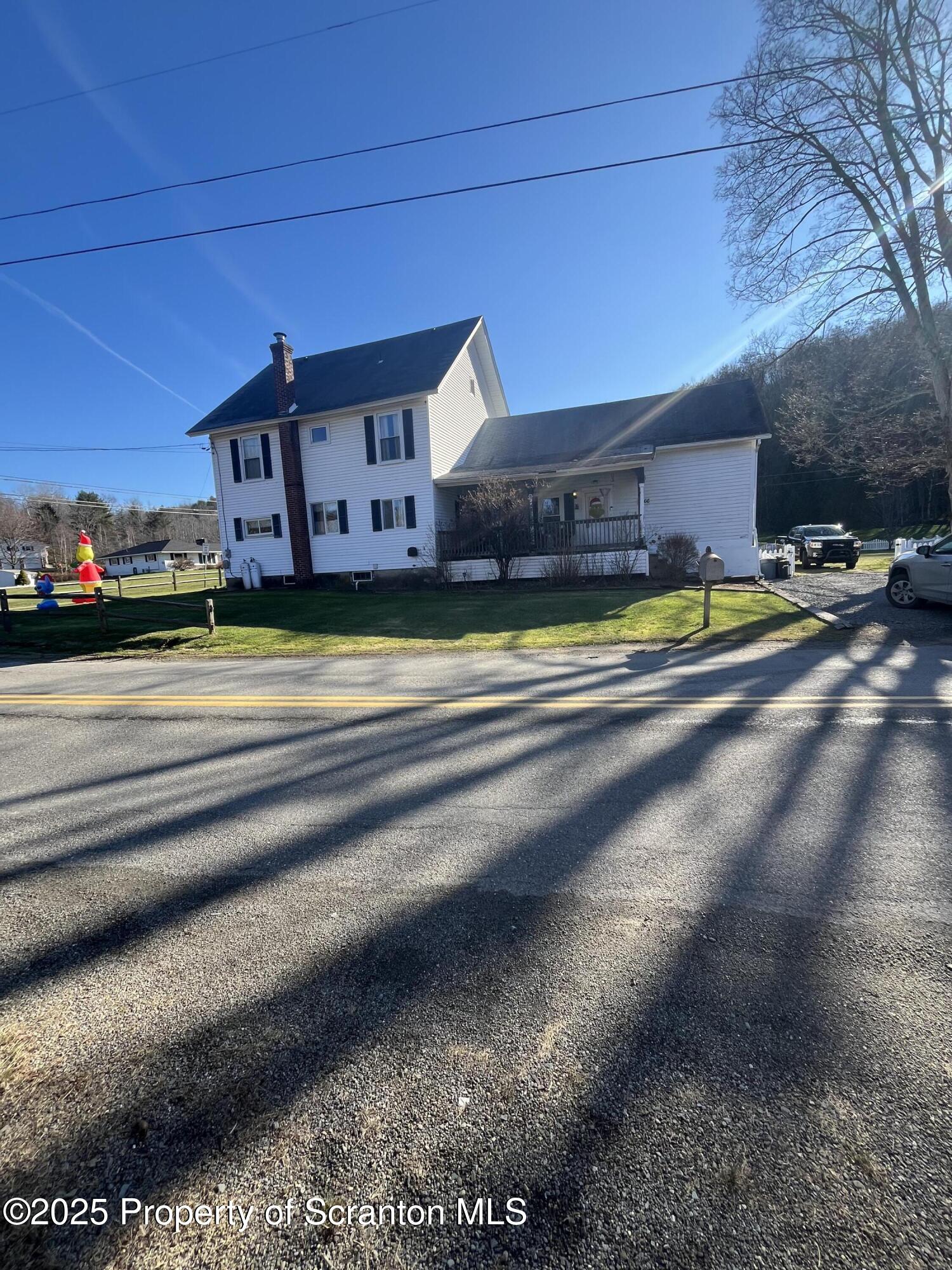 a view of pool with a yard