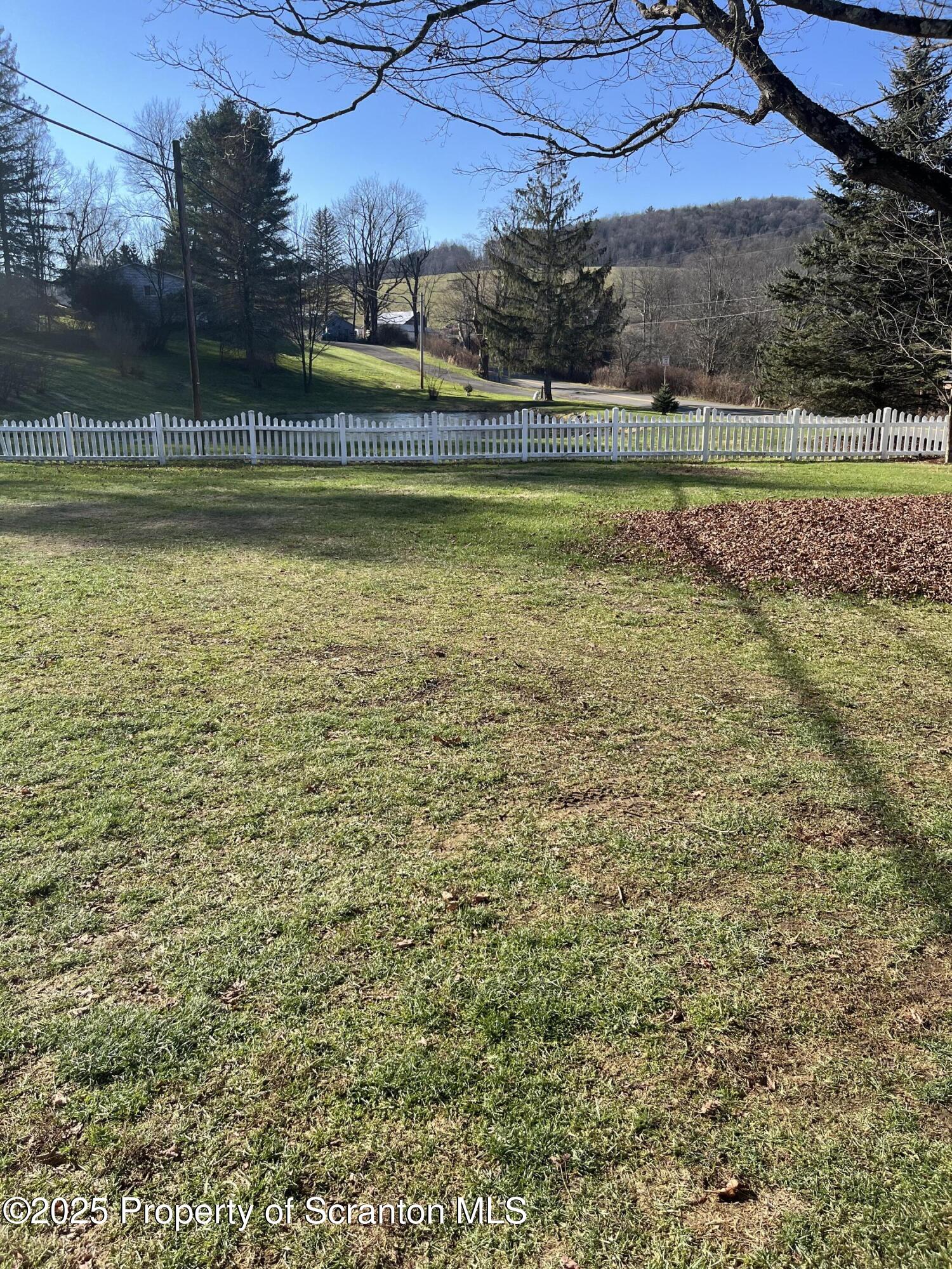 6666 Tingley Lake Road New Milford, PA 18834 - Photo 15 of 45 a view of a swimming pool with an outdoor space and seating area