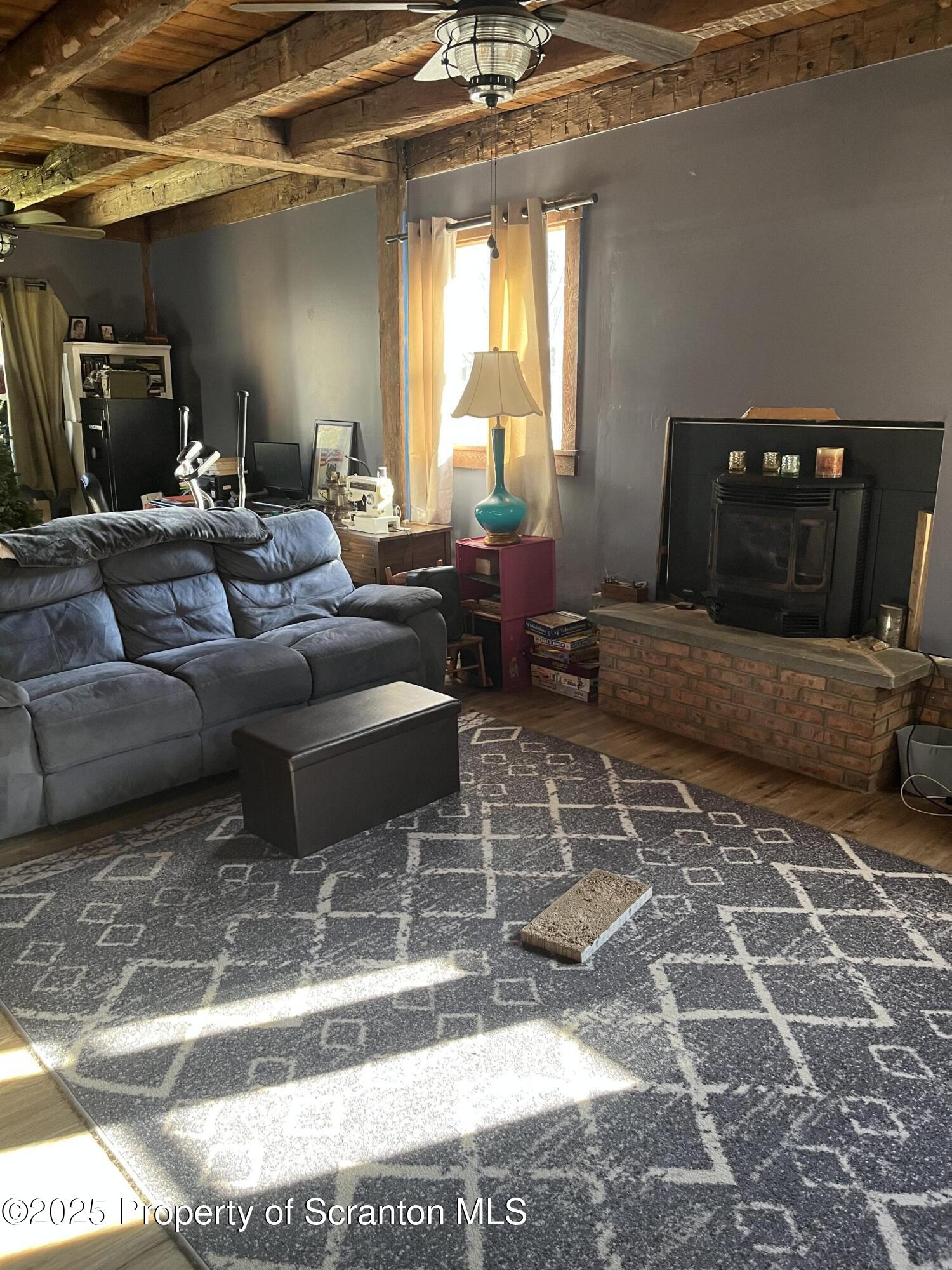 6666 Tingley Lake Road New Milford, PA 18834 - Photo 17 of 45 a living room with furniture and a flat screen tv