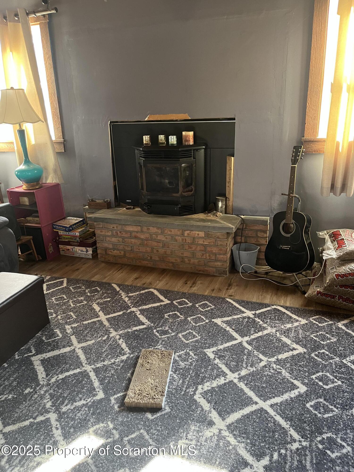 6666 Tingley Lake Road New Milford, PA 18834 - Photo 19 of 45 a living room with a couch and a potted plant