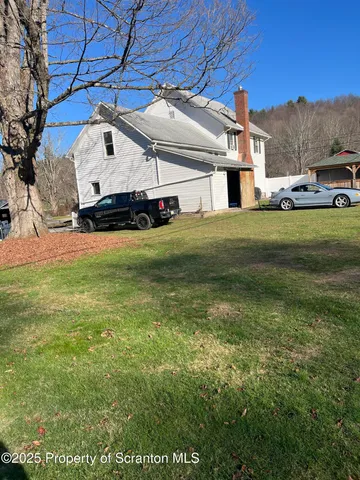a view of a big house with a big yard