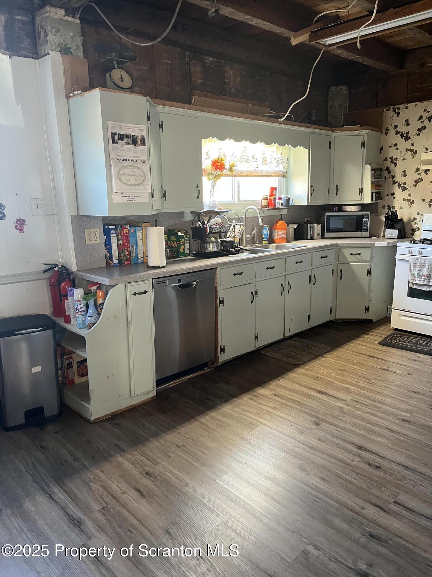 6666 Tingley Lake Road New Milford, PA 18834 - Photo 22 of 45 a kitchen with stainless steel appliances granite countertop a sink window and cabinets