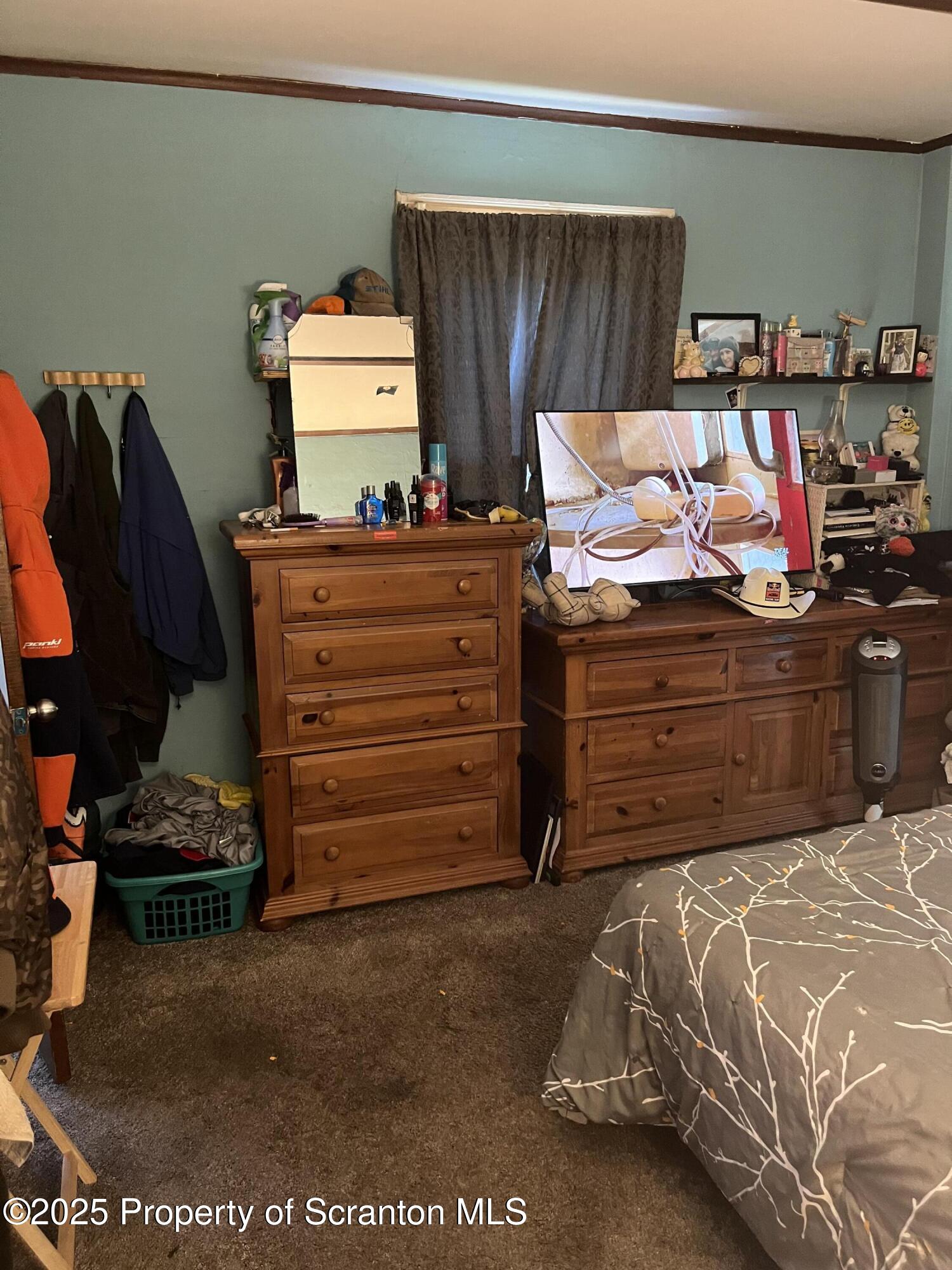 6666 Tingley Lake Road New Milford, PA 18834 - Photo 29 of 45 a bed room with a bed and a chair