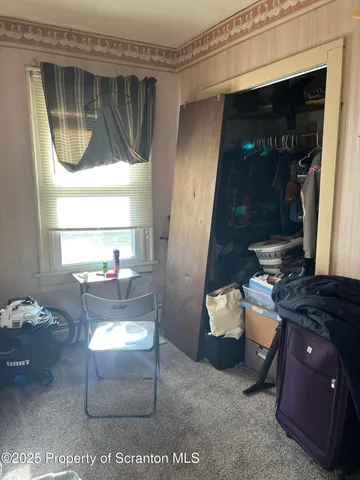 a view of a patio with table and chairs under an umbrella